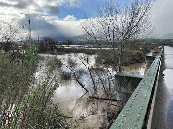 flooded bridge but sun coming out and giving the feeling of relief